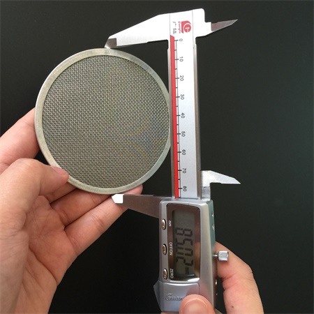 The outer diameter of the mesh disc is being measured by a callipers.